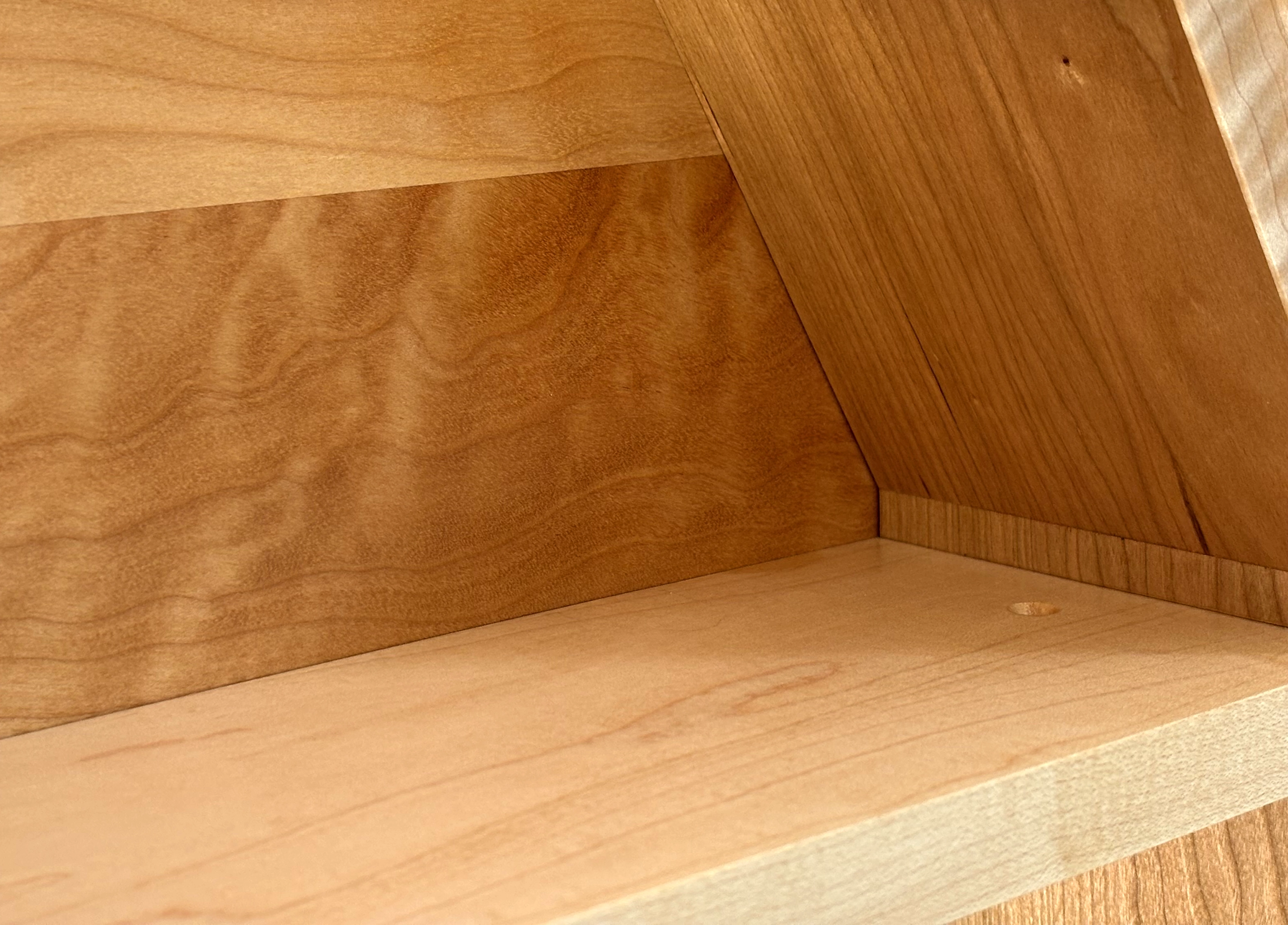 Close-up detail of handmade oversized hardwood wall clock face and grain