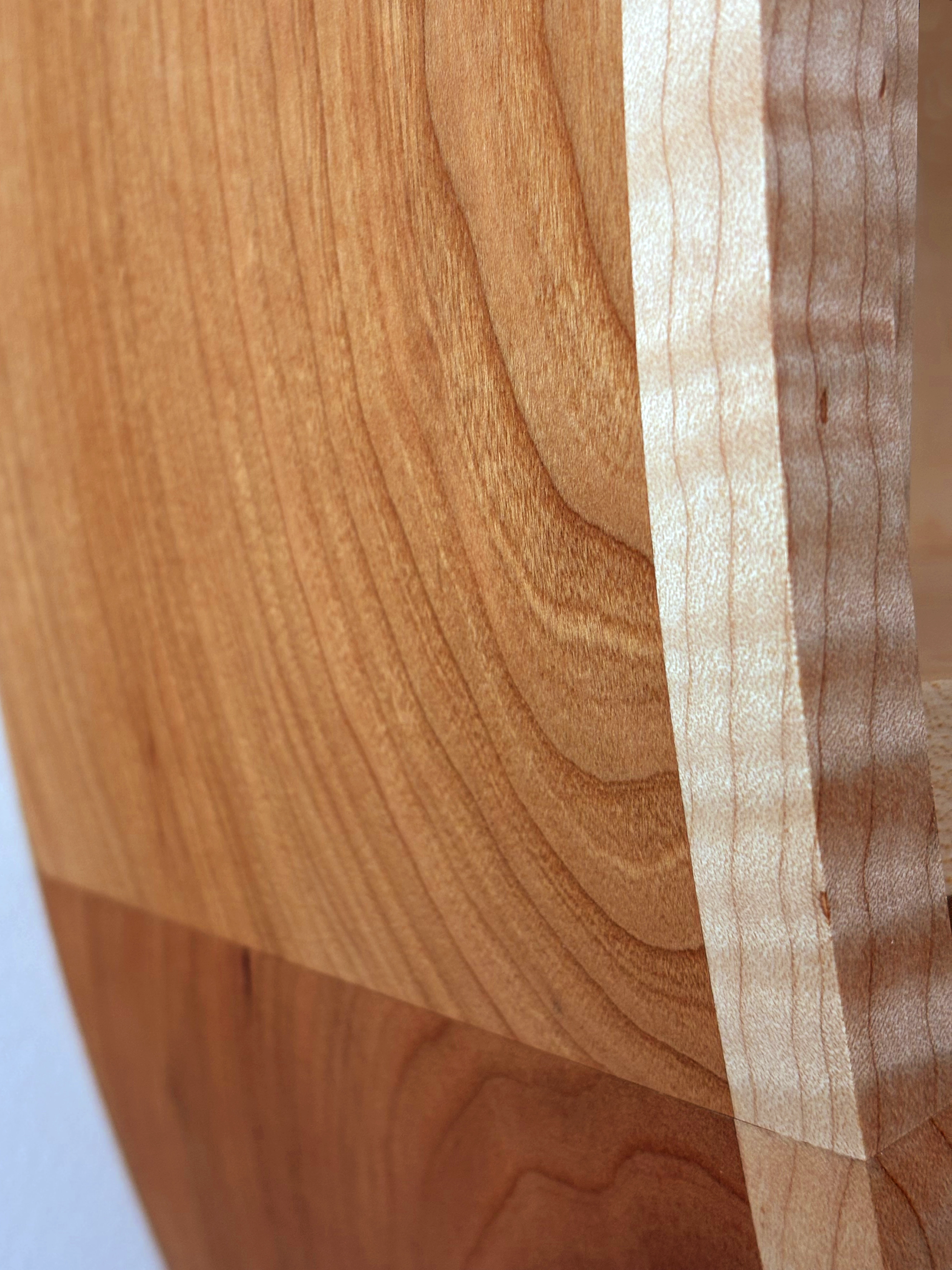 Close-up showing figured maple and epoxy details on oversized wall clock