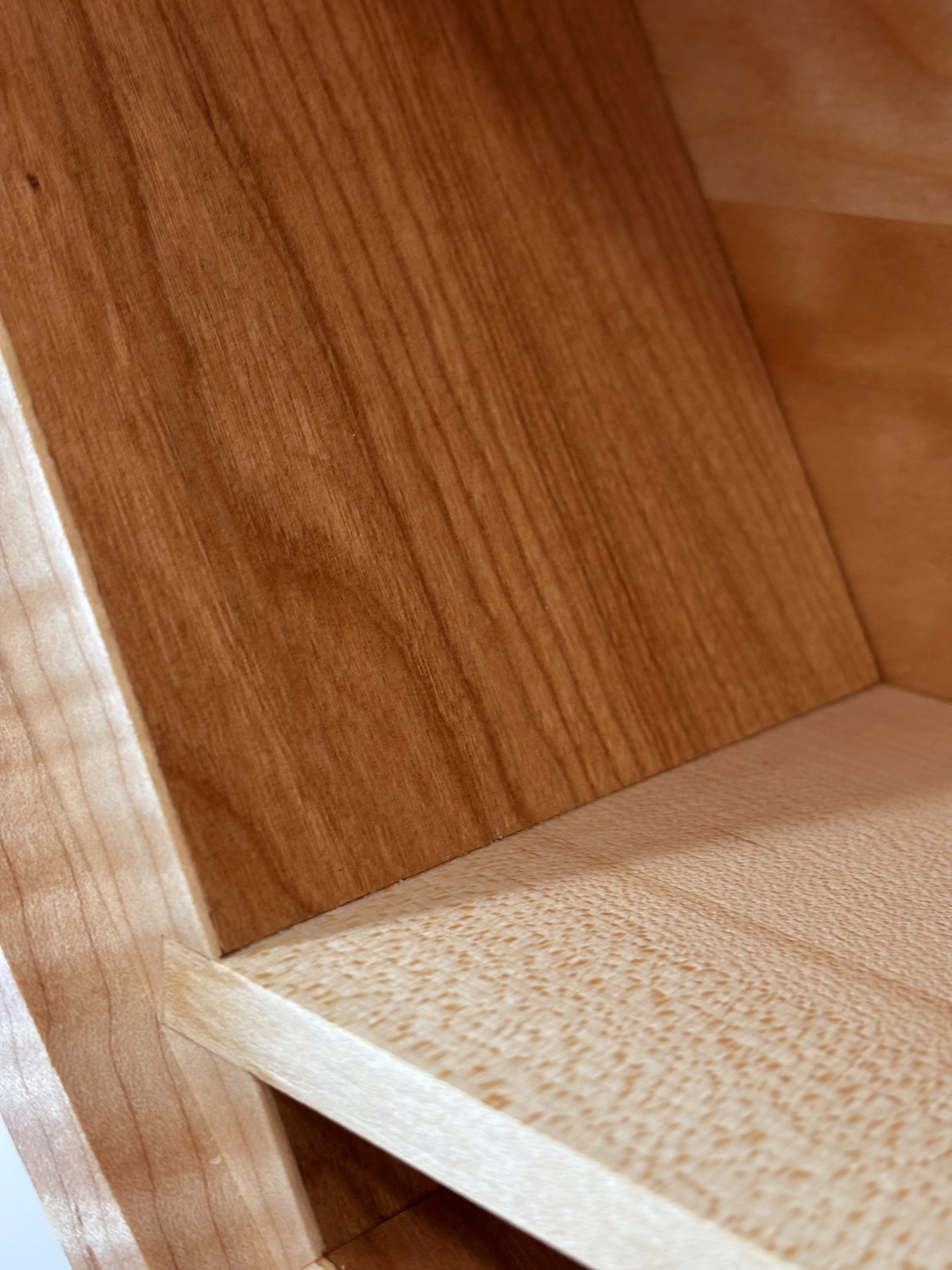 Close-up of handcrafted hardwood joinery and finish on featured wall clock